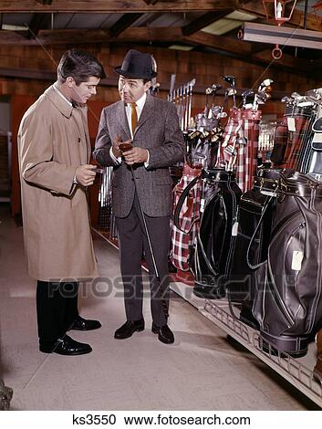 1960S Two Men In Golf Equipment Shop Talking And Discussing Purchase Of A Driver Golf Club View Large Photo Image Stock Image - 1960S Two Men In Golf Equipment Shop Talking And Discussing Purchase Of A Driver Golf Club . Fotosearch