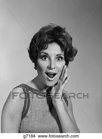 1960S Woman Mouth Open Wide Hand To Cheek Shouting Surprised Amazed Facial Expression View Large Photo Image Picture - 1960S Woman Mouth Open Wide Hand To Cheek Shouting Surprised Amazed Facial Expression. Fotosearch