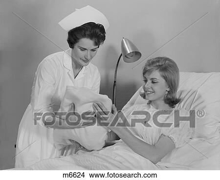 1960S Woman Nurse Giving Baby To Smiling Mother Patient Sitting In Hospital Bed View Large Photo Image Picture - 1960S Woman Nurse Giving Baby To Smiling Mother Patient Sitting In Hospital Bed. Fotosearch