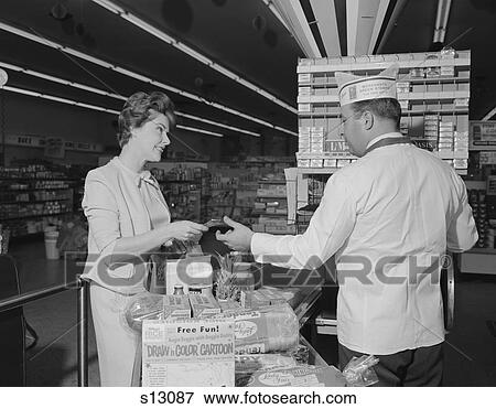 1960S Woman Paying At Grocery Store Checkout Male Cashier View Large Photo Image Stock Photo - 1960S Woman Paying At Grocery Store Checkout Male Cashier. Fotosearch