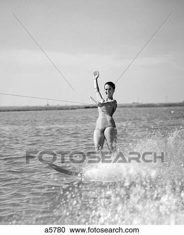 1960S Woman Water Skiing Waving With One Hand View Large Photo Image Stock Image - 1960S Woman Water Skiing Waving With One Hand. Fotosearch