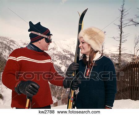 Stock Photo - 1960S Young Couple In Snow With Snow Skis. Fotosearch