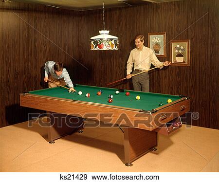 1970 1970S Two Men Teens Playing Pool Table Wood Paneled Rec Recreation Room Stained Glass Lamp Billiards Retro View Large Photo Image Stock Photo - 1970 1970S Two Men Teens Playing Pool Table Wood Paneled Rec Recreation Room Stained Glass Lamp Billiards Retro . Fotosearch
