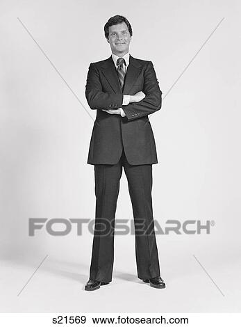 1970S 1980S Smiling Man Standing Wearing Business Suit View Large Photo Image Stock Photo - 1970S 1980S Smiling Man Standing Wearing Business Suit. Fotosearch