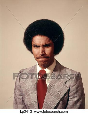 Stock Image - 1970S African American Business Man In Suit Afro Hair Style Frustrated Mad Angry Mean Upset Facial Expression Looking At Camera . Fotosearch