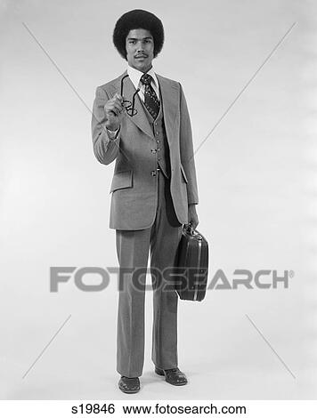 1970S African American Business Man Three Piece Suit Briefcase Pointing With Eyeglasses View Large Photo Image Stock Photograph - 1970S African American Business Man Three Piece Suit Briefcase Pointing With Eyeglasses. Fotosearch