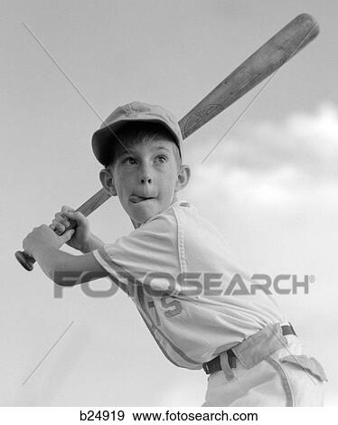 Stock Photo - 1970S Boy Playing Baseball Holding Bat Ready To Hit The Ball. Fotosearch