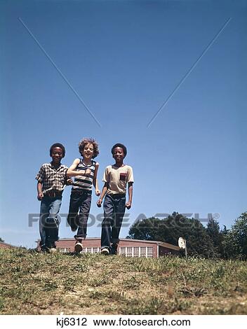 1970S Boys Two African American One Caucasian Walking Together After School View Large Photo Image Stock Image - 1970S Boys Two African American One Caucasian Walking Together After School. Fotosearch