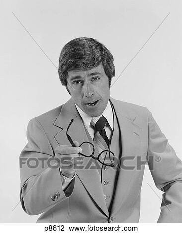 1970S Businessman Serious Expression Pointing With Eyeglasses Looking At Camera View Large Photo Image Stock Image - 1970S Businessman Serious Expression Pointing With Eyeglasses Looking At Camera. Fotosearch