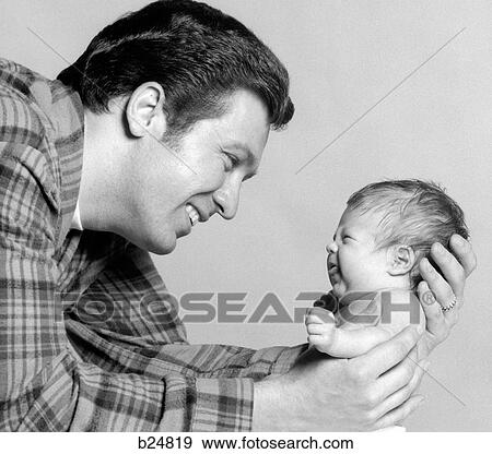 1970S Close-Up Portrait Of Smiling Father Holding Pouting Newborn View Large Photo Image Stock Photo - 1970S Close-Up Portrait Of Smiling Father Holding Pouting Newborn. Fotosearch