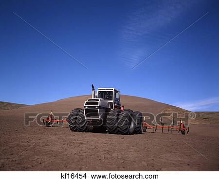1970S Farm Tractor Pulling Weeder Apparatus In Field View Large Photo Image Picture - 1970S Farm Tractor Pulling Weeder Apparatus In Field. Fotosearch