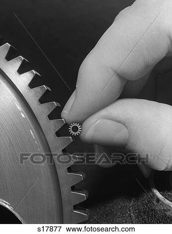 1970S Hands Holding Tiny Gear Alongside Larger Gear View Large Photo Image Stock Photo - 1970S Hands Holding Tiny Gear Alongside Larger Gear. Fotosearch