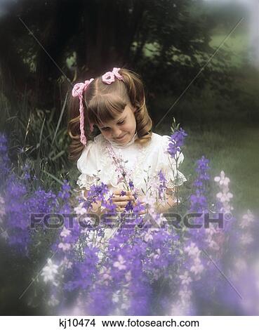 1970S Little Girl Pigtails Pink Ribbons With Purple Flowers View Large Photo Image Picture - 1970S Little Girl Pigtails Pink Ribbons With Purple Flowers. Fotosearch