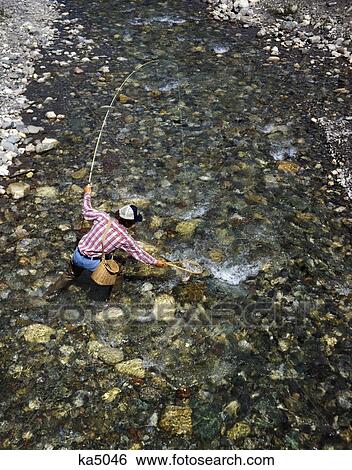 Stock Photograph - 1970S Man Fisherman Swift Current Lake Glacier National Park Montana. Fotosearch