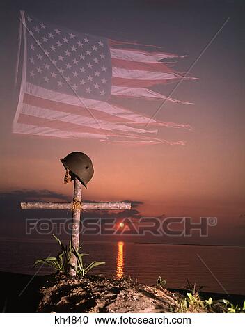 1970S Montage Tattered American Flag Sunset Soldiers Military Helmet On Cross Grave Marker View Large Photo Image Stock Image - 1970S Montage Tattered American Flag Sunset Soldiers Military Helmet On Cross Grave Marker . Fotosearch