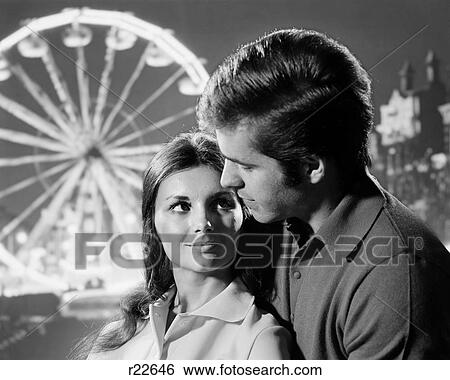 1970S Portrait Of Romantic Couple With Background Of Amusement Park At Night View Large Photo Image Stock Photograph - 1970S Portrait Of Romantic Couple With Background Of Amusement Park At Night. Fotosearch
