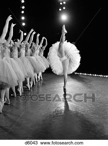 1970S Side View Of Prima Ballerina In Standing Split With Row Of 8 Backing Dancers With Arms Raised Behind Her View Large Photo Image Stock Image - 1970S Side View Of Prima Ballerina In Standing Split With Row Of 8 Backing Dancers With Arms Raised Behind Her. Fotosearch