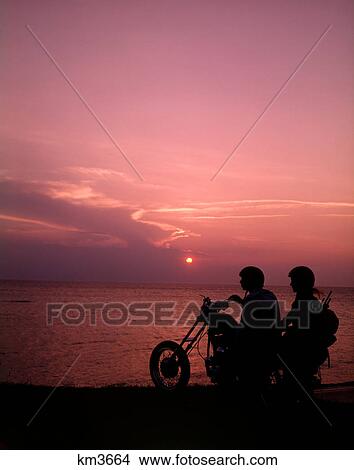 1970S Silhouetted Couple Sunset Beach Riding Chopper Motorcycle Bike Motor Cycle Motorcycles Bikers Bikes View Large Photo Image Picture - 1970S Silhouetted Couple Sunset Beach Riding Chopper Motorcycle Bike Motor Cycle Motorcycles Bikers Bikes. Fotosearch