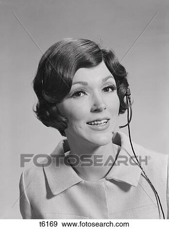 Stock Photo - 1970S Smiling Brunette Woman Wearing Telephone Head Set . Fotosearch