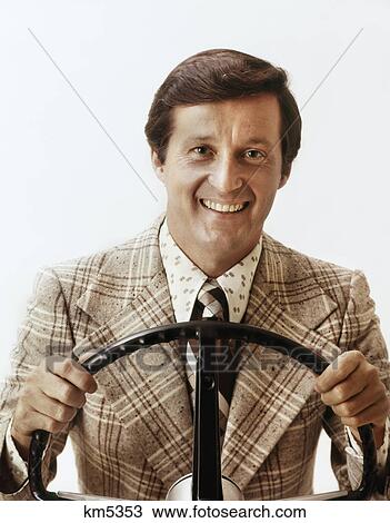 1970S Smiling Man Wearing Loud Print Shirt Tie Plaid Sport Jacket Holding Steering Wheel Driving Car Looking At Camera View Large Photo Image Stock Image - 1970S Smiling Man Wearing Loud Print Shirt Tie Plaid Sport Jacket Holding Steering Wheel Driving Car Looking At Camera. Fotosearch