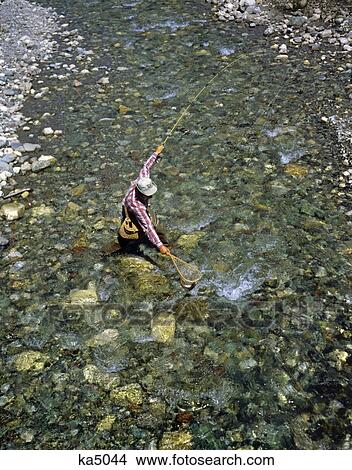 1970S Trout Fisherman, Swift Current Lake, Glacier Park, Montana View Large Photo Image Picture - 1970S Trout Fisherman, Swift Current Lake, Glacier Park, Montana. Fotosearch