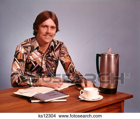 1970S Young Man Mustache Loud Print Shirt Desk Empty Coffee Cup Pot Working On Family Budget Looking At Camera View Large Photo Image Picture - 1970S Young Man Mustache Loud Print Shirt Desk Empty Coffee Cup Pot Working On Family Budget Looking At Camera . Fotosearch