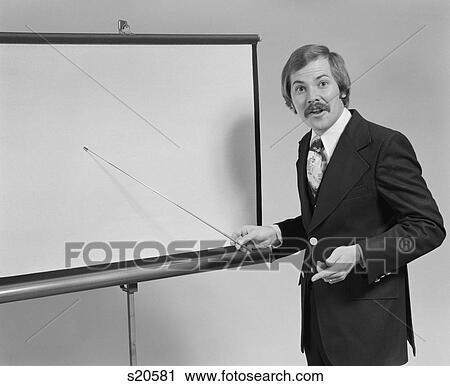 1970S Young Man Speaking Pointing To Blank Slide Screen For Presentation View Large Photo Image Stock Image - 1970S Young Man Speaking Pointing To Blank Slide Screen For Presentation. Fotosearch