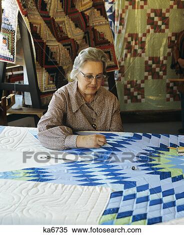 1980S 1970S Senior Woman Quilting Sewing Quilt With Blue Star Pattern View Large Photo Image Stock Photography - 1980S 1970S Senior Woman Quilting Sewing Quilt With Blue Star Pattern. Fotosearch