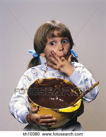 1980S 1990S Little Girl Eating Chocolate Icing From Bowl View Large Photo Image Stock Image - 1980S 1990S Little Girl Eating Chocolate Icing From Bowl . Fotosearch