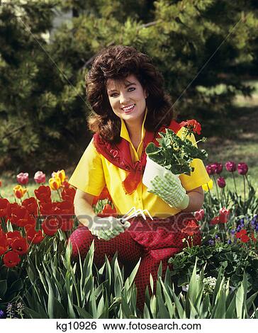 Stock Photograph - 1980S 1990S Smiling Brunette Young Woman Gardening . Fotosearch