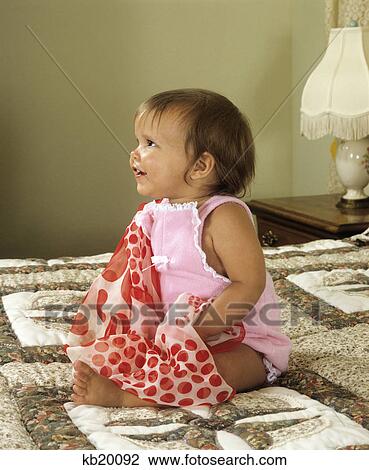 1980S Baby Girl Wearing Pink Smiling Sitting On Quilt View Large Photo Image Stock Image - 1980S Baby Girl Wearing Pink Smiling Sitting On Quilt. Fotosearch