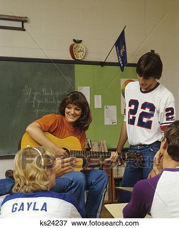 1980S College Students In Classroom Playing Guitar View Large Photo Image Stock Photo - 1980S College Students In Classroom Playing Guitar. Fotosearch