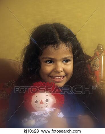 1980S Hispanic Girl Clutching Raggedy Ann Doll View Large Photo Image Stock Photo - 1980S Hispanic Girl Clutching Raggedy Ann Doll. Fotosearch