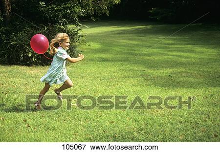 1980S Little Girl With A Red Balloon Running In The Grass View Large Photo Image Stock Photo - 1980S Little Girl With A Red Balloon Running In The Grass . Fotosearch