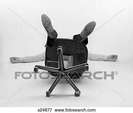 1980S Man Only See Arms Legs Bottom Of Office Chair Fallen Over Backwards View Large Photo Image Stock Photo - 1980S Man Only See Arms Legs Bottom Of Office Chair Fallen Over Backwards. Fotosearch