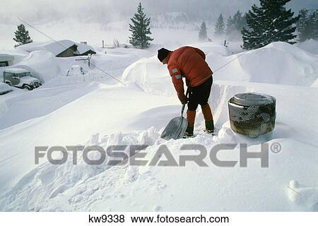 Stock Photo - 1980S Man Shoveling Snow Off House Roof Mammoth Lakes California Usa. Fotosearch