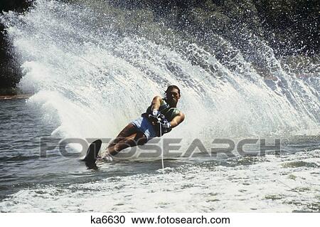 1980S Man Waterskiing Making Fan Of Water View Large Photo Image Stock Image - 1980S Man Waterskiing Making Fan Of Water . Fotosearch