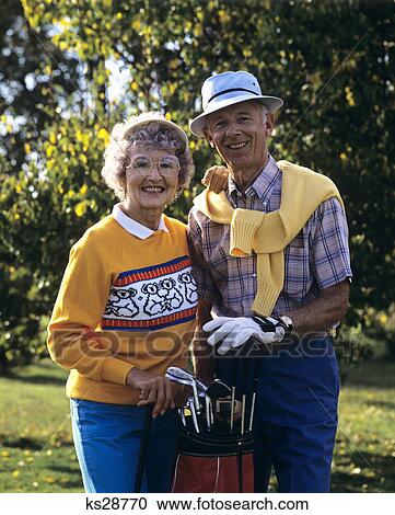 1980S Portrait Of Older Couple With Golf Bag Looking At Camera View Large Photo Image Stock Image - 1980S Portrait Of Older Couple With Golf Bag Looking At Camera. Fotosearch