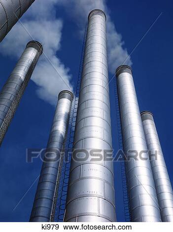 1980S Tall Silver Metal Smoke Stacks Emitting Smoke View Large Photo Image Stock Photo - 1980S Tall Silver Metal Smoke Stacks Emitting Smoke. Fotosearch