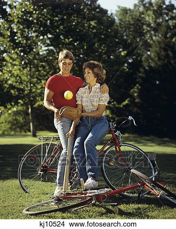 1980S Teen Couple With Bicycle Baseball Mitt And Bat View Large Photo Image Picture - 1980S Teen Couple With Bicycle Baseball Mitt And Bat . Fotosearch