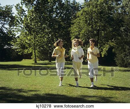 Stock Photo - 1980S Three Teen Girls Jogging In Park. Fotosearch