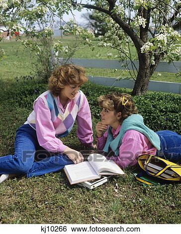 1980S Two Teenage Girls Under Blossoming Tree Reading Studying Talking View Large Photo Image Stock Photograph - 1980S Two Teenage Girls Under Blossoming Tree Reading Studying Talking . Fotosearch