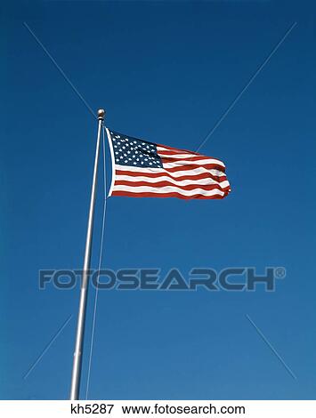 1980S United States Flag Flying On Flagpole In Blue Cloudless Sky View Large Photo Image Stock Photo - 1980S United States Flag Flying On Flagpole In Blue Cloudless Sky. Fotosearch