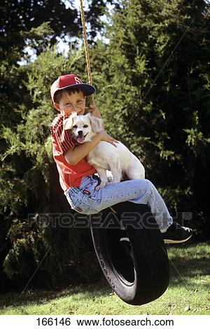 1990S Boy And Dog Riding On Tire Swing View Large Photo Image Stock Photograph - 1990S Boy And Dog Riding On Tire Swing . Fotosearch