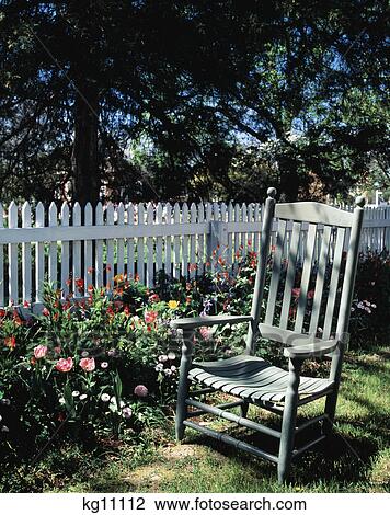 1990S Empty Chair In Garden By Flowers And White Picket Fence View Large Photo Image Stock Image - 1990S Empty Chair In Garden By Flowers And White Picket Fence. Fotosearch