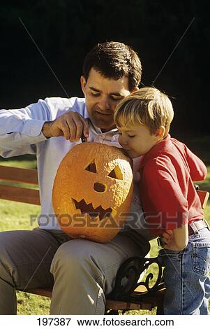 1990S Father And Son Carving A Halloween Pumpkin Outdoors View Large Photo Image Stock Photo - 1990S Father And Son Carving A Halloween Pumpkin Outdoors . Fotosearch
