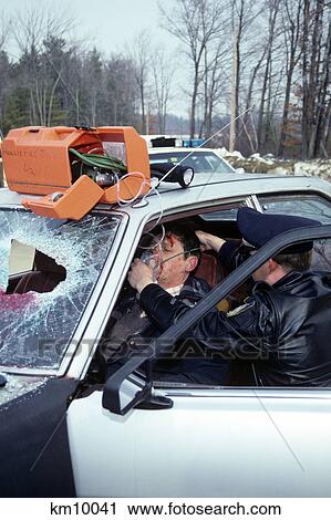 1990S Police Officer Administering Oxygen To Automobile Accident Victim View Large Photo Image Stock Image - 1990S Police Officer Administering Oxygen To Automobile Accident Victim. Fotosearch