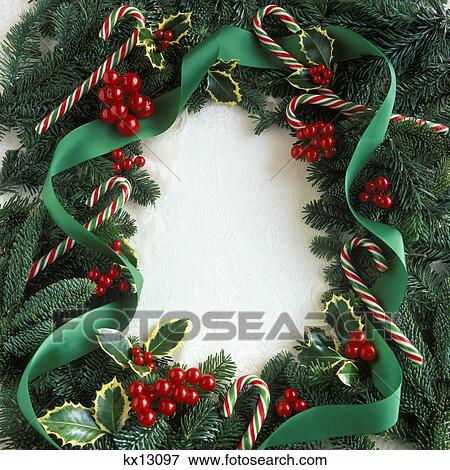Stock Photo - 2000S Christmas Wreath Of Greens Holly And Candy Canes. Fotosearch