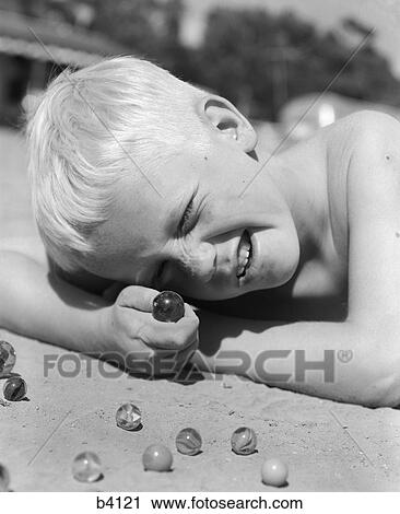Boy Crouching Shooting Marbles Concentration View Large Photo Image Stock Image - Boy Crouching Shooting Marbles Concentration. Fotosearch