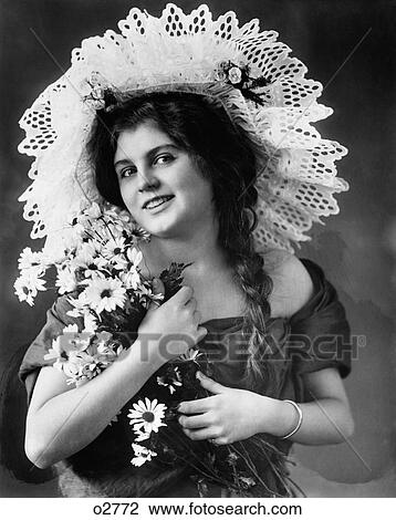 1900S 1910S Turn Of The Century Woman With Long Braids Wearing Fancy Lace Hat & Holding Bouquet Of Black-Eyed Susan Flowers View Large Photo Image Stock Image - 1900S 1910S Turn Of The Century Woman With Long Braids Wearing Fancy Lace Hat & Holding Bouquet Of Black-Eyed Susan Flowers. Fotosearch